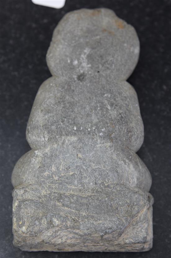 A Gandharan grey schist seated figure of Buddha, 2nd-4th century AD height 25.5cm
